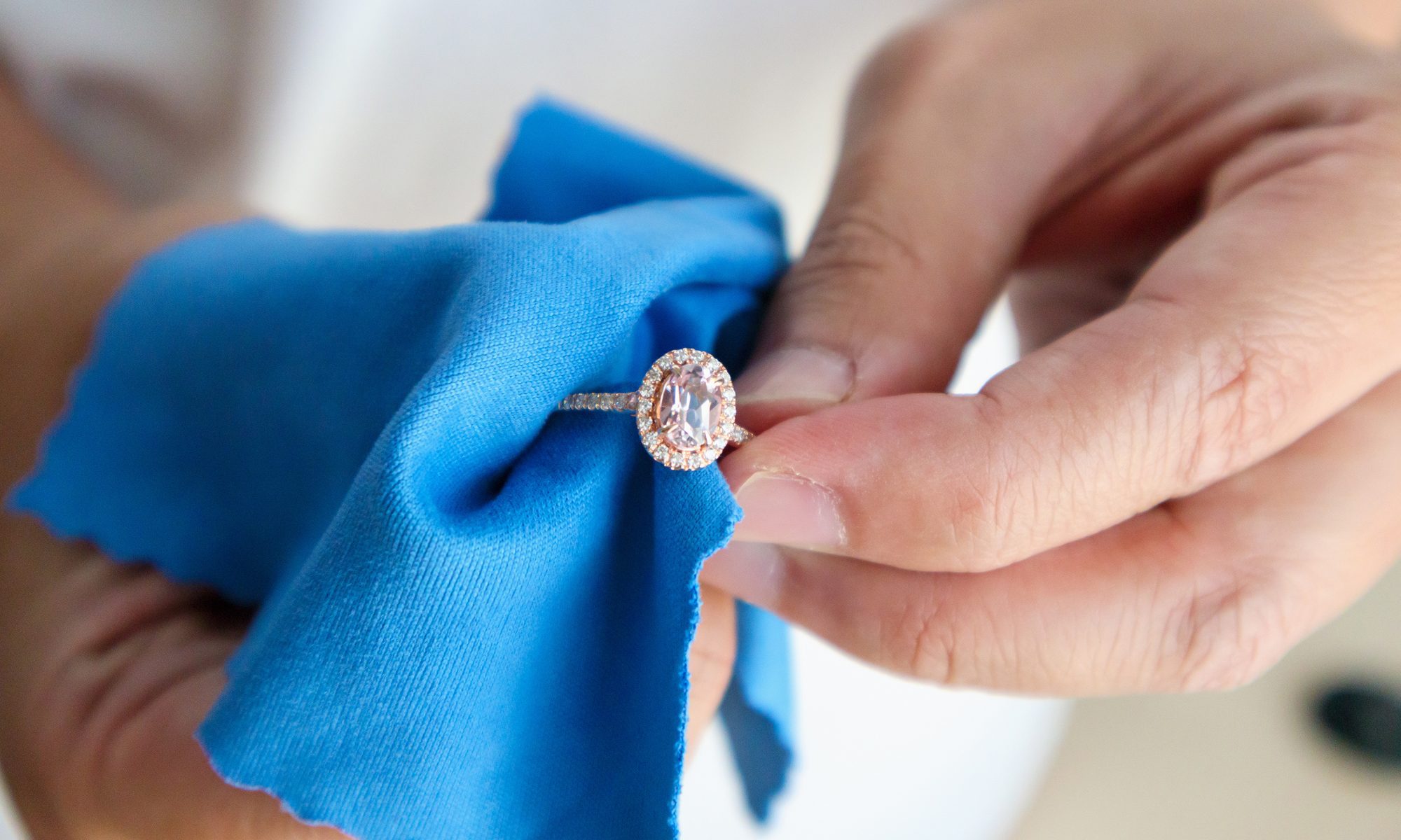 Cleaning diamond ring with microfiber rag, concept for Custom Designed Jewelry Near St. John